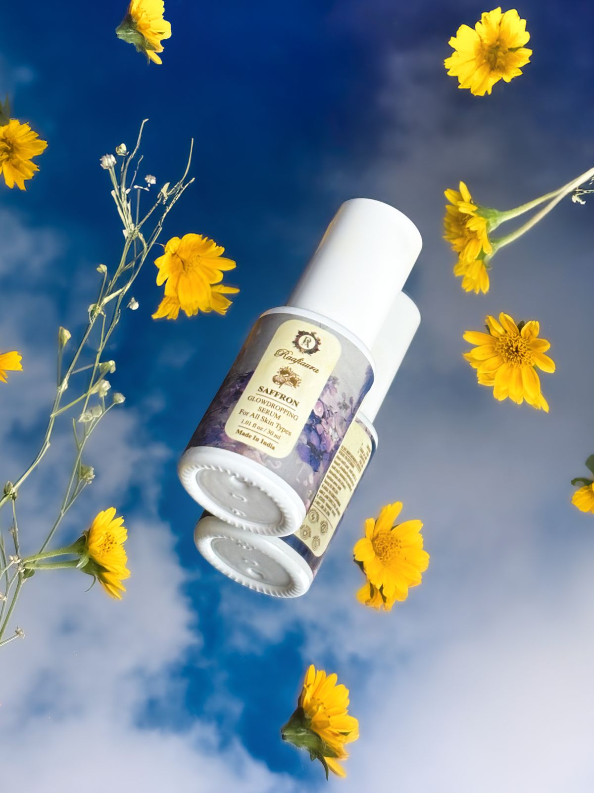 Saffron Glow Dropping Serum by Raafiaura surrounded by yellow flowers against a blue sky backdrop