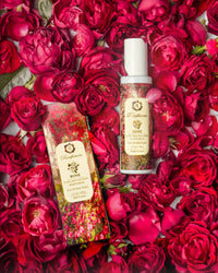 Raafiaura Skin Soothing Rose Moisturiser Bottle Among Fresh Pink Roses for Hydrating Skincare