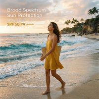 Model enjoying the beach wearing a sundress with Sunveda Aqua Sunscreen for broad spectrum protection