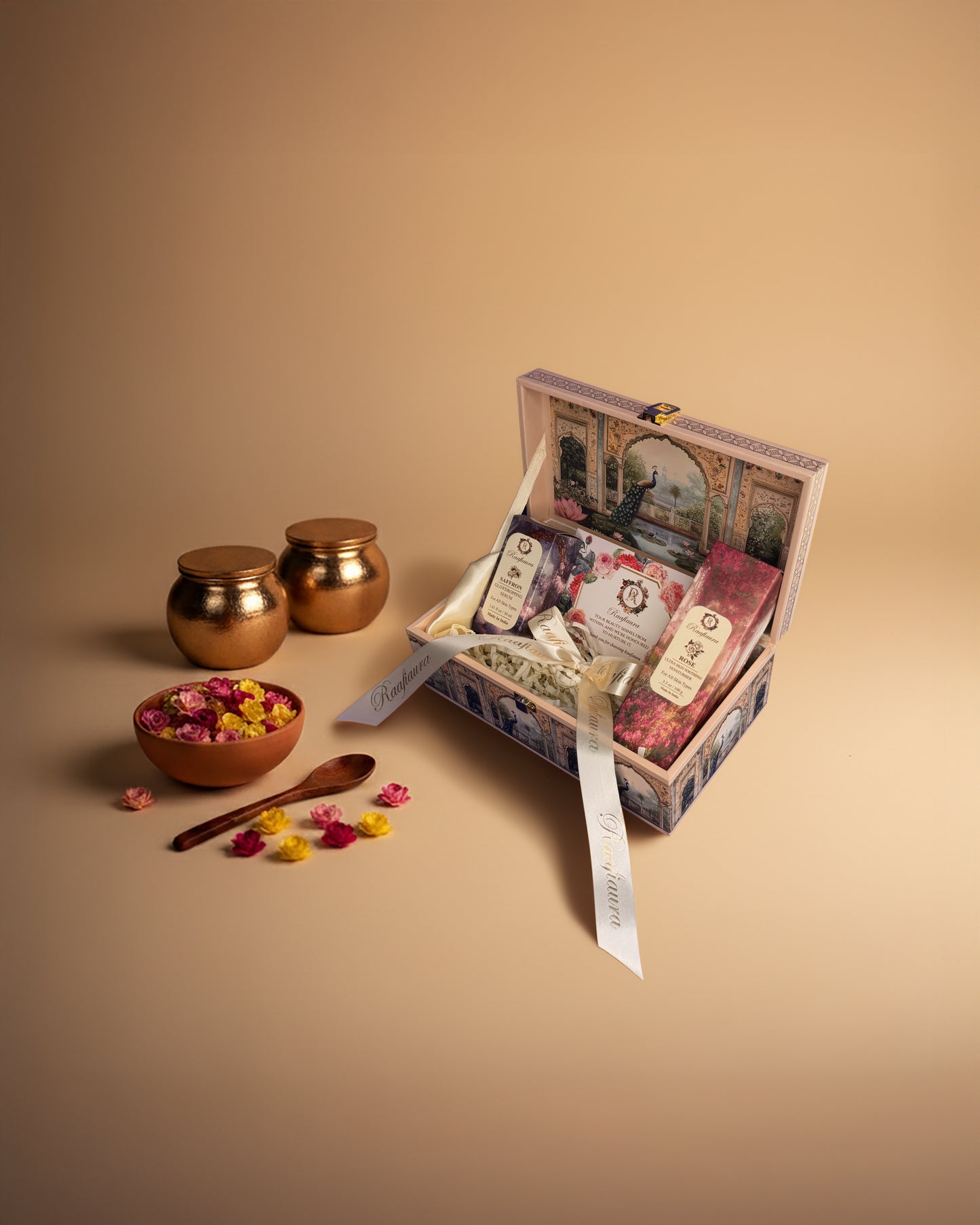 Raafiaura Gifting Box Mystique Elegance with decorative items and vibrant flower petals