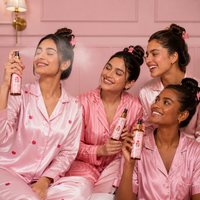 Four women enjoying Raafiaura Pink Peta Face Mist in cozy pajamas for a refreshing skincare routine